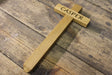 Wooden cross with 'Casper' engraved on it, placed on a wooden surface.  Memorial Cross